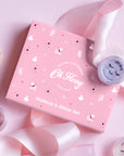 Pink makeup set with 'Oh Floppy' branding on a pink background