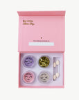 Makeup set with four containers and applicators in a pink box with 'Be Little, Shine Big' text.
