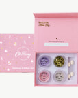 Makeup and glitter set with 'Oh Flossy' branding in a pink box.