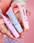 Oh-Flossy-Kids-Natural-Makeup-Lip-gloss-trio-set-on-hands