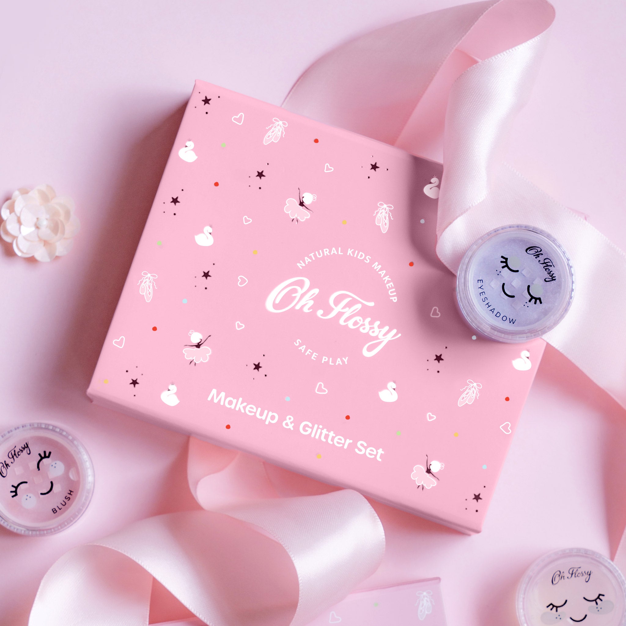 Pink makeup set with 'Oh Floppy' branding on a pink background