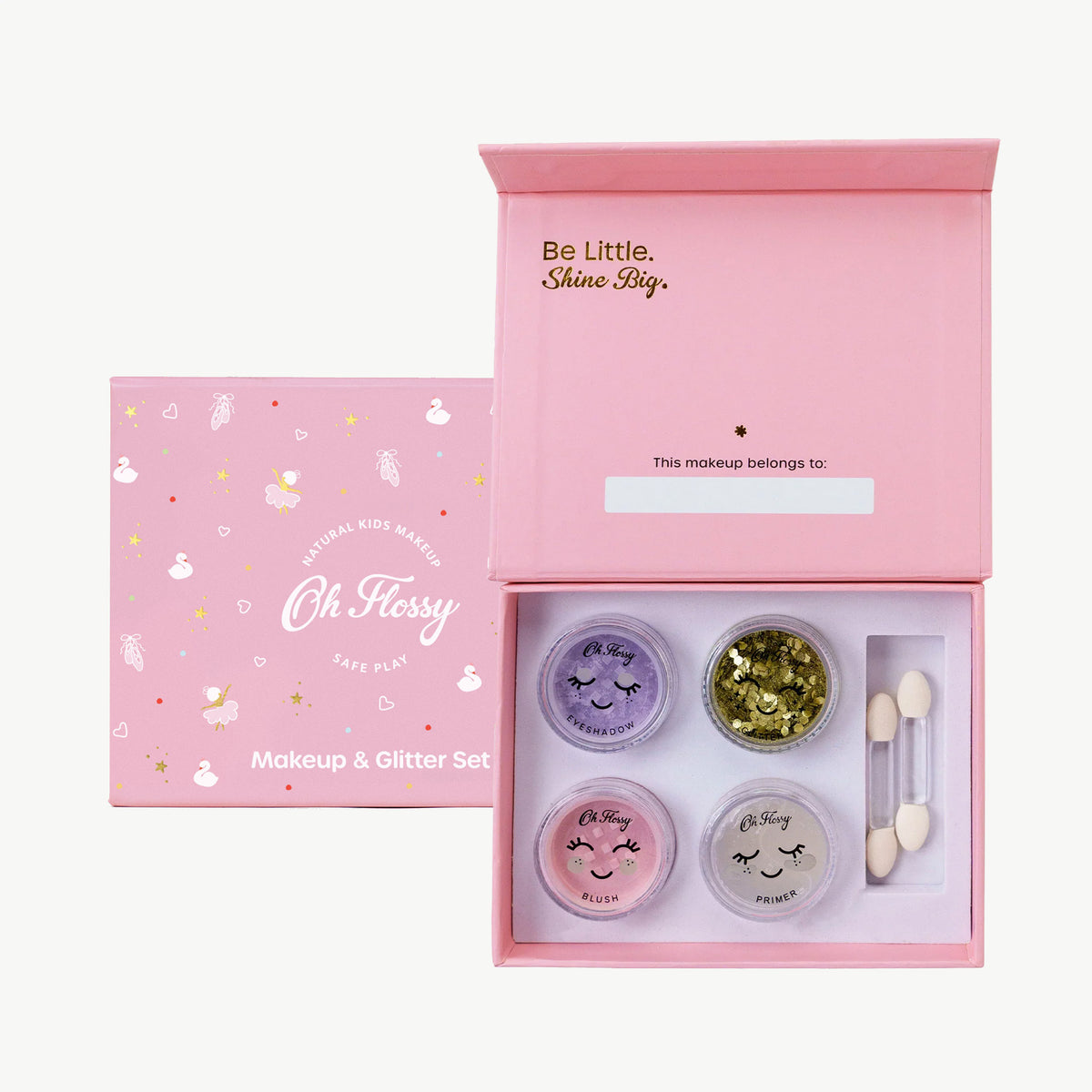 Makeup and glitter set with 'Oh Flossy' branding in a pink box.